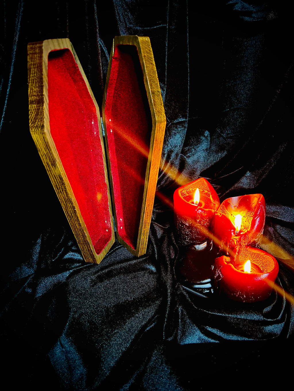 Wood coffin keepsake box with velvet flocked interior and hinged lid.