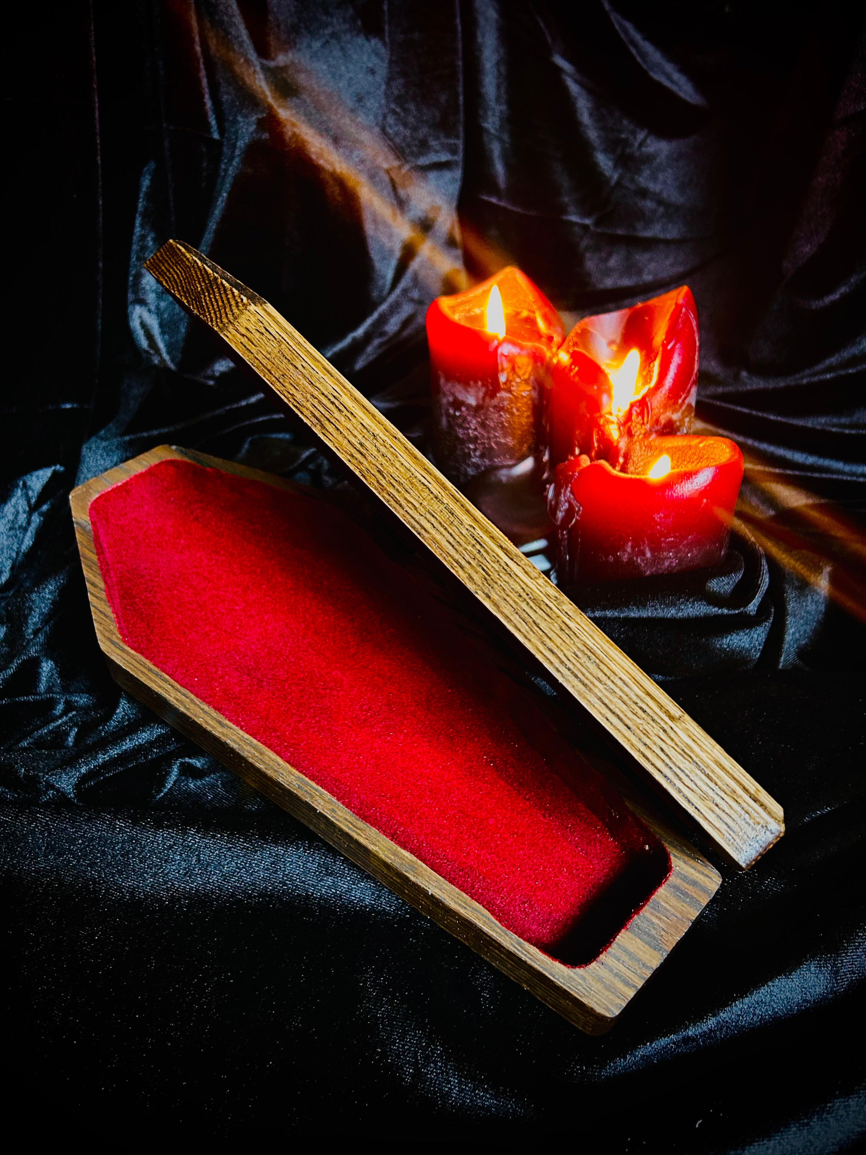 Wood coffin keepsake box with velvet flocked interior and hinged lid.
